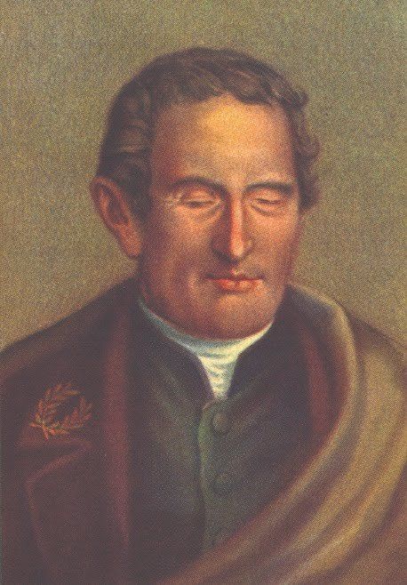 A imagem é uma pintura do retrato de Louis Braille que era um homem branco, com cabelo curto e castanho. Está vestindo uma  capa, debaixo tem um terno verde e dentro uma camisa branca.  